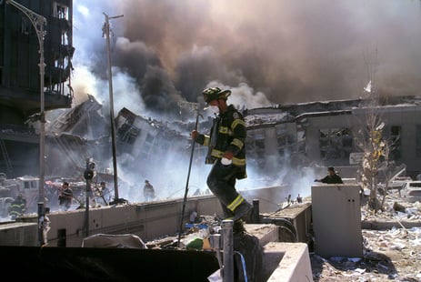 Fire_fighters_amid_smoking_rubble_after_September_11th_terrorist_attack_(29392249476)